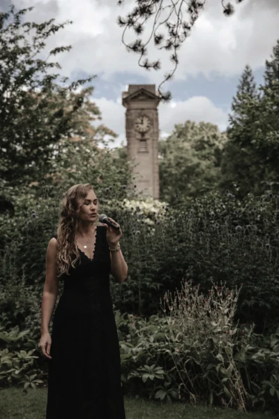 Wedding & event singer Songbird Gebby singing in front of Clock Tower